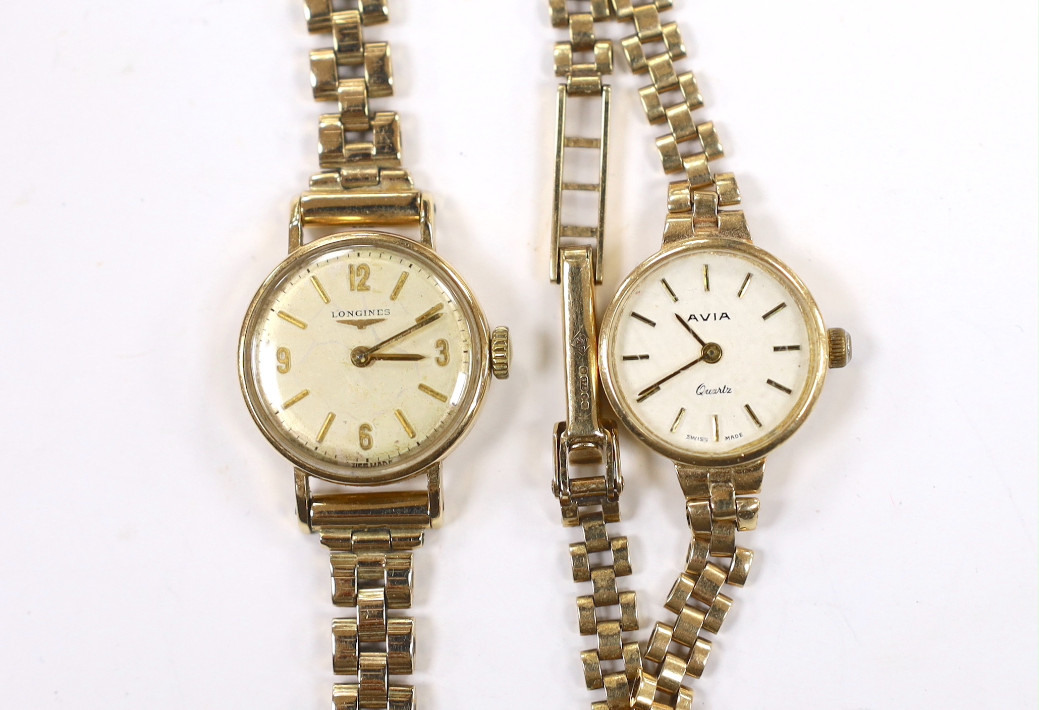 A lady's 9ct gold Longines manual wind wrist watch, on a 9ct gold bracelet and a similar Avia quartz wrist watch, gross weight 34.1 grams.